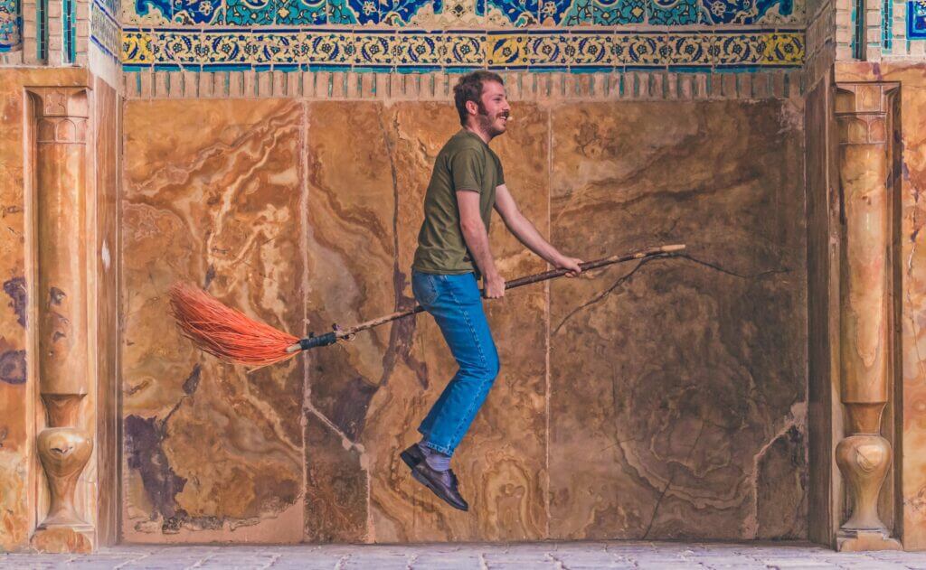 man riding on levitation broom painting
