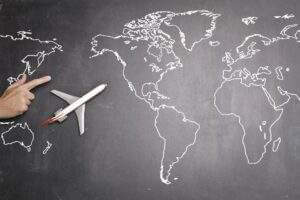 airplane over world map on blackboard