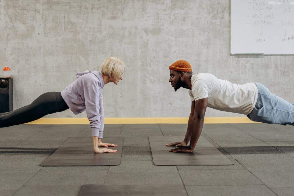 man and woman doing push up