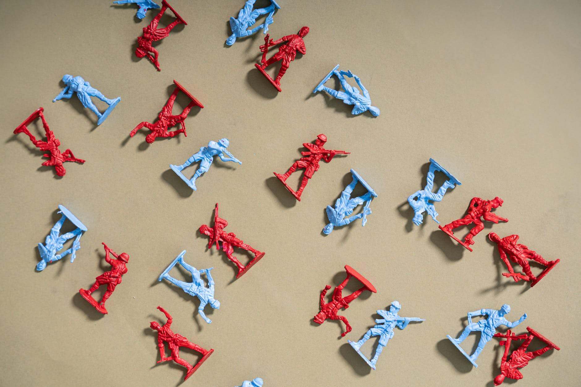 red and blue plastic toy soldiers on brown surface