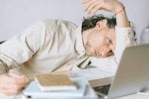 overworked employee lying in front of laptop