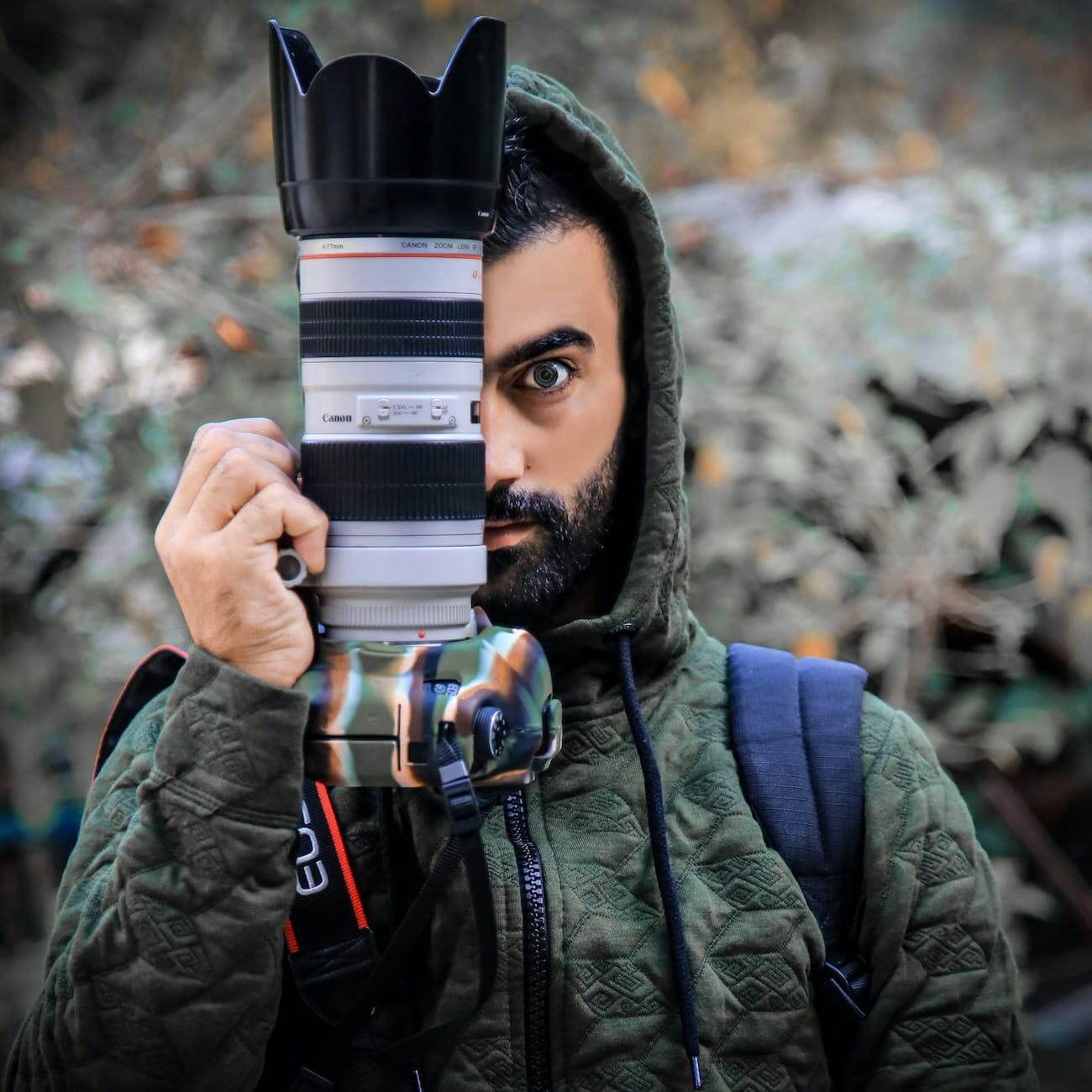 person holding a dslr camera