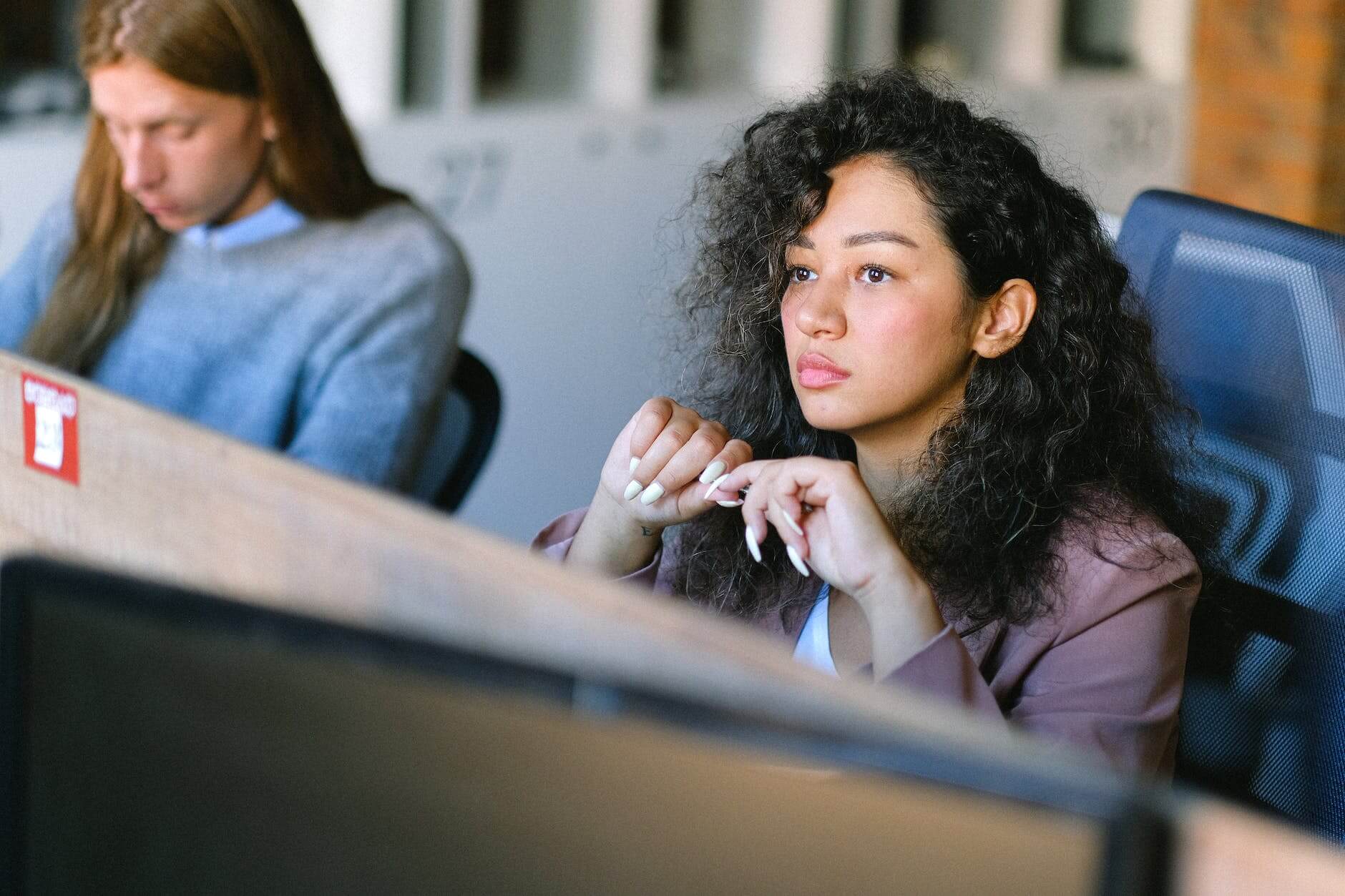 focused woman thinking on problem in office