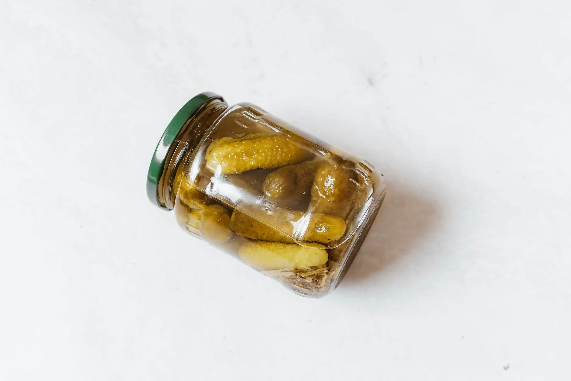 a pickled cucumbers on a glass jar